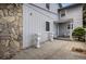Grey home exterior with stone accents and landscaped patio at 2813 S Xanadu Way, Aurora, CO 80014