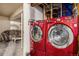 Red washer and dryer in a laundry room with a small sitting area at 2813 S Xanadu Way, Aurora, CO 80014