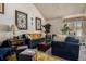 Cozy living room featuring a stone fireplace and comfortable seating at 2813 S Xanadu Way, Aurora, CO 80014