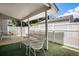 Covered outdoor patio area with seating and privacy fence at 2813 S Xanadu Way, Aurora, CO 80014