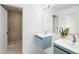 Modern bathroom featuring double vanity sinks, blue cabinets, sleek mirrors, and a glass-enclosed shower with stylish tile at 5462 S Cedar St, Littleton, CO 80120