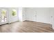 Bright bedroom with wood flooring, two closets, a window, and a glass door to a balcony, offering ample space and natural light at 5462 S Cedar St, Littleton, CO 80120