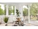 Bright dining area with modern table, chairs, natural light, and access to the outdoor deck at 5462 S Cedar St, Littleton, CO 80120
