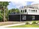 Contemporary two-story home showcasing rooftop decks, expansive windows, and meticulously landscaped yard at 5462 S Cedar St, Littleton, CO 80120