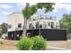 Modern two-story home featuring rooftop decks, sleek black metal siding, and professional landscaping at 5462 S Cedar St, Littleton, CO 80120