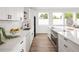 Modern kitchen featuring white cabinetry, quartz countertops, stainless steel appliances, and a bright, airy feel at 5462 S Cedar St, Littleton, CO 80120