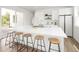 Spacious kitchen island with quartz countertop, modern stools, and stylish decor, creating an ideal gathering space at 5462 S Cedar St, Littleton, CO 80120