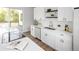 Bright kitchen with white cabinets, modern appliances, quartz countertops, and a seamless flow to the outdoor patio at 5462 S Cedar St, Littleton, CO 80120