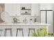 Modern kitchen featuring white cabinets, quartz countertops, sleek island, and stainless steel appliances at 5462 S Cedar St, Littleton, CO 80120