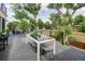 Outdoor patio area with dining table, chairs, and scenic views of surrounding greenery at 5462 S Cedar St, Littleton, CO 80120