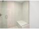 Elegant glass enclosed shower with a built-in bench, marble-style walls, and a tiled floor, creating a luxurious experience at 5462 S Cedar St, Littleton, CO 80120