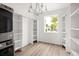 Large walk-in closet with custom shelving, ample storage, and a modern chandelier at 5462 S Cedar St, Littleton, CO 80120