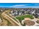 Neighborhood aerial view showcasing modern homes and a park with playgrounds at 16546 Umatilla Place, Broomfield, CO 80023