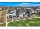 Aerial view of modern homes, a park, and beautiful mountain views at 16546 Umatilla Place, Broomfield, CO 80023