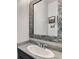 Close up of a bathroom sink, granite countertops, and a decorative mirror with stone trim at 16546 Umatilla Place, Broomfield, CO 80023