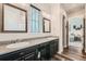 Modern bathroom features dual sinks, granite countertops, and sleek fixtures, with views to another room at 16546 Umatilla Place, Broomfield, CO 80023