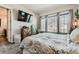 Comfortable bedroom featuring a large bed, TV, and dresser with decor, near natural light from window at 16546 Umatilla Place, Broomfield, CO 80023