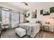 Bright bedroom featuring a plush bed with decorative pillows, soft carpet, and natural light at 16546 Umatilla Place, Broomfield, CO 80023