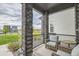 Covered front porch with comfortable outdoor seating and views of the community at 16546 Umatilla Place, Broomfield, CO 80023