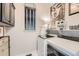 Well-lit laundry room featuring modern appliances, storage cabinets, and a stylish Buddha portrait at 16546 Umatilla Place, Broomfield, CO 80023