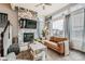 Cozy living room with a modern fireplace, large window, and comfortable seating at 16546 Umatilla Place, Broomfield, CO 80023