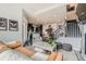 Open-concept living area with dark cabinetry in kitchen, hardwood floors, and natural light at 16546 Umatilla Place, Broomfield, CO 80023