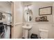Stylish powder room with pedestal sink, wainscoting, and tasteful decor at 16546 Umatilla Place, Broomfield, CO 80023
