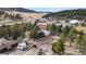 Charming two-story home with a fenced yard, detached garage, and an expansive view of the surrounding landscape at 3046 S Alpine Dr, Evergreen, CO 80439