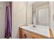 Bright bathroom features a vanity with a white countertop and a shower with a patterned curtain at 3046 S Alpine Dr, Evergreen, CO 80439