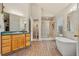 Bathroom features a modern tub, walk-in shower, and vanity with a bright sink at 3046 S Alpine Dr, Evergreen, CO 80439