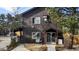 Charming home featuring a covered porch and lush landscaping, perfect for enjoying the outdoors at 3046 S Alpine Dr, Evergreen, CO 80439