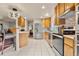 Bright kitchen featuring stainless steel appliances, tile flooring and a breakfast bar at 3046 S Alpine Dr, Evergreen, CO 80439