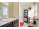 Functional bathroom featuring black shelving, a red accent rug, and a walk-in shower at 5563 S Elk Ct, Aurora, CO 80016