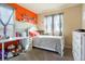 Inviting bedroom with ample natural light, a white bed, and colorful decorations at 5563 S Elk Ct, Aurora, CO 80016