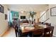 Stylish dining area with wood table, seating for six, flowing into the living room and stair access to the upper level at 5563 S Elk Ct, Aurora, CO 80016