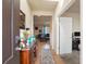 Welcoming entryway with hardwood floors, a console table with decor, and views into the living room and an office space at 5563 S Elk Ct, Aurora, CO 80016