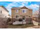 Back exterior of a house with stone accents and a patio, perfect for outdoor living at 5563 S Elk Ct, Aurora, CO 80016