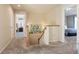 Upstairs hallway features neutral carpeting, natural wood banister, and views into bedrooms at 5563 S Elk Ct, Aurora, CO 80016