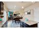 Open-concept living area with hardwood floors, a fireplace, a flat-screen TV, and seamless access to the adjacent dining space at 5563 S Elk Ct, Aurora, CO 80016