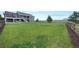 Expansive backyard with lush lawn, mature trees, and a wooden fence for privacy and space at 6785 Arrowhead Cir, Elizabeth, CO 80107