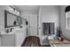 Stylish bathroom featuring a double vanity, a soaking tub, and modern fixtures at 6785 Arrowhead Cir, Elizabeth, CO 80107