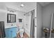 Finished basement bathroom with a shower-tub combo and blue vanity at 6785 Arrowhead Cir, Elizabeth, CO 80107