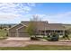 Charming ranch-style home with a three-car garage and covered porch, set against a beautiful blue sky backdrop at 6785 Arrowhead Cir, Elizabeth, CO 80107
