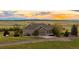 Charming single-Gathering home features a well-manicured lawn and a gravel driveway leading up to a 2-car garage at 6785 Arrowhead Cir, Elizabeth, CO 80107