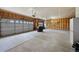 Spacious three car garage with paneled walls, concrete floor, and automatic door openers at 6785 Arrowhead Cir, Elizabeth, CO 80107
