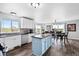 Bright, modern kitchen featuring stainless steel appliances, an island and adjacent dining area with views of the property at 6785 Arrowhead Cir, Elizabeth, CO 80107