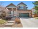Charming two-story home with brick exterior, inviting porch and professionally maintained landscaping at 24702 E Hoover Pl, Aurora, CO 80016
