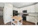 Bright kitchen featuring white cabinets, stainless steel appliances, and a kitchen island at 24702 E Hoover Pl, Aurora, CO 80016
