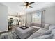 Spacious living room connected to a modern kitchen featuring a large sectional sofa at 24702 E Hoover Pl, Aurora, CO 80016