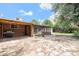 Outdoor patio area with brick paving, pergola, screened in porch, and ample backyard space at 12154 E Virginia Dr, Aurora, CO 80012